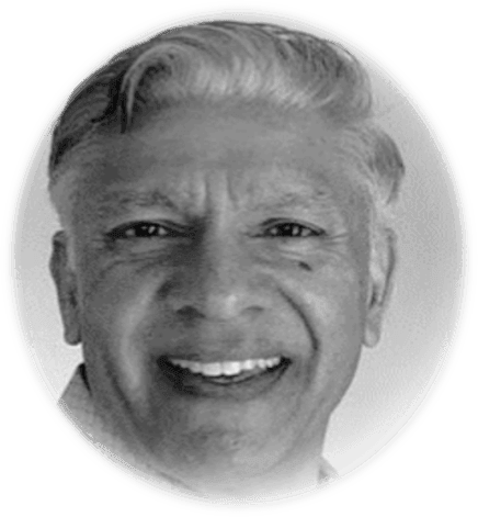 Smiling person in a black and white oval-framed photo.